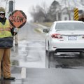 Mark Glover with Decco Contractors Paving handles traffic control Wednesday as crews work to level s...