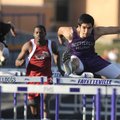 Jorge Gonzalez, right, of Fayetteville clears a hurdle March 9 during the 110-meter hurdles in the a...