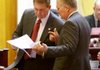 Rep. Allen Kerr, R-Little Rock, (left) and Rep. John Edwards, D-Little Rock, confer Friday at the state Capitol. House members Friday voted to create an advisory board to help plan development of a new state veterans home, a project Edwards has championed. 
