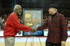 NWA Media/MICHAEL WOODS --02/02/2013-- Former University of Arkansas basketball coach Nolan Richardson shakes hand with artist Opie Otterstad during a halftime presentation of Saturday afternoon's game against Tennessee at Bud Walton Arena in Fayetteville.
