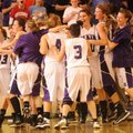 Elkins players, coaches and fans react to the Lady Elks’ 39-35 win over Greenland to secure the team...