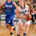 McKinzie James of Rogers High drives past Springdale High’s Javonda Daniels on Friday at King Arena ...