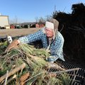 Randy Bond of Elkins unloads brush Saturday at Fayetteville’s Compost Facility after cleaning up aro...