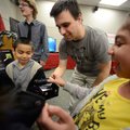 Jason Quail, center, with Take3.NWA shows Aailiya Gonzalez, 9, left, of Rogers, her brother Oscar, 5...