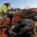 David Einsele works Friday to compact dirt around new drainage that has been laid as work begins to ...