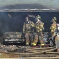 Rogers firefighters work a house fire Sunday afternoon at 313 E. Lilac St. in Rogers. The fire start...
