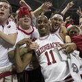 Arkansas' BJ Young (11) celebrates with fans after their 80-69 win over No. 2 Florida in an NCAA col...