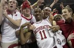 Arkansas' BJ Young (11) celebrates with fans after their 80-69 win over No. 2 Florida in an NCAA college basketball game in Fayetteville, Ark., Tuesday, Feb. 5, 2013. (AP Photo/Gareth Patterson)