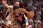Auburn's Bryant Smith (13) drives the lane as Arkansas' Pat Bradley, left, guards him during the second half Wednesday, Feb. 24, 1999, in Bud Walton Arena in Fayetteville, Ark. Arkansas won 104-88. (AP Photo/Gary Yandell)