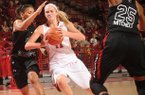 Arkansas sophomore guard Calli Berna, center, drives with the basketball as South Carolina senior guard Ieasia Walker, left, and freshman guard Tiffany Mitchell, right, defend during the second half Sunday, Jan. 27, 2013, in Bud Walton Arena.