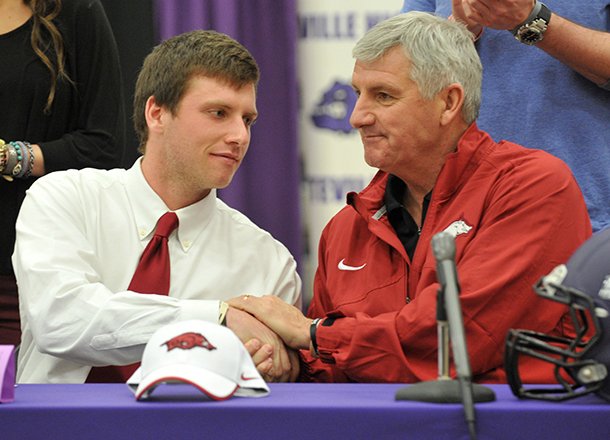 nwa-mediamichael-woods-02062013-fayetteville-highs-austin-allen-shakes-hands-with-his-father-bobby-allen-after-signing-his-letter-of-intent-to-play-football-at-the-university-of-arkansas-during-the-official-signing-ceremony-wednesday-afternoon-at-fayetteville-high-school