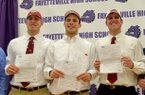 Fayetteville High students (left to right) Brooks Ellis, Alex Brignoni and Austin Allen get ready to pose for a group photo after they signed their letters of intent to play football at the University of Arkansas during the official ceremony Wednesday afternoon. 