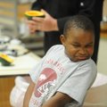 Jaxon Oliver, 6, of Fayetteville reacts Tuesday to watching chef Adam Simmons, child nutrition direc...