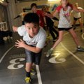 Nicolas Lorennij, left, gets limber with other athletes during a speed and agility class Tuesday at ...