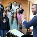 Alan Showalter, choir director at Southwest Junior High School, leads the Harmony Choir through a pr...