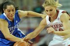 Kentucky defender Jennifer O'Neill knocks the ball away from Arkansas' Erin Gatling during the first half of Thursday night's game against the Wildcats at Bud Walton Arena in Fayetteville.