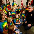 Fayetteville Police Cpl. David Williams talks Wednesday with members of the Gator Choir from Central...