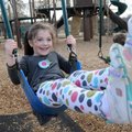 Eden Venable, 4, shows off her swinging skills Wednesday while playing with her brother and grandfat...
