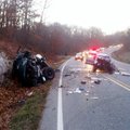 A man sets flares Wednesday morning to warn approaching traffic of a fatal accident on Arkansas 12 n...