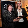 Jill Darling, left, with the Northwest Arkansas United Way, presents the Live United award Wednesday...