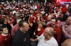 Arkansas Coach Bret Bielema (left) talks with Dennis Welch on Thursday during the Signing Day in the Rock event at Verizon Arena in North Little Rock. 