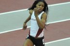 University of Arkansas runner Regina George runs the final turn in the women's 400 M Invitational at the Tyson Invitational track meet at the Randal Tyson Track Complex in Fayetteville.