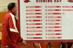 University of Arkansas head football coach Bret Bielema walks past the signing day list of 22 players who committed to the Razorbacks as he begins the press conference Wednesday afternoon in Fayetteville.