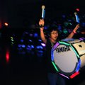 Martine Ngiam, 13, celebrates Thursday after the drum line finishes performing at the annual glow-in...