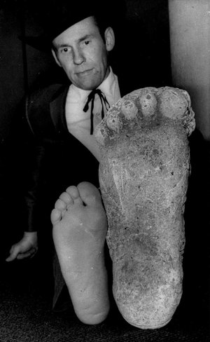 Fouke Mayor Terry Lee compares a plaster cast of a possible Bigfoot print with his foot last month. 
