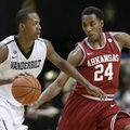 Vanderbilt forward Rod Odom, left, drives against Arkansas guard Michael Qualls (24) during the firs...