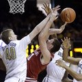 Arkansas forward Hunter Mickelson, second from left, loses the ball as he tries to shoot among Vande...