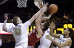 Arkansas forward Hunter Mickelson, second from left, loses the ball as he tries to shoot among Vanderbilt defenders Josh Henderson (40), Dai-Jon Parker (24) and Kevin Bright, right, during the first half of an NCAA college basketball game on Saturday, Feb. 9, 2013, in Nashville, Tenn. (AP Photo/Mark Humphrey)