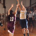 Betsy Burns, right, a Haas Hall Academy senior guard, takes a shot over Alpena freshman Amber Ray du...