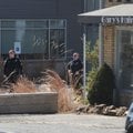 Fayetteville Police Department personnel secure the scene Friday at KUAF studio in Fayetteville. 