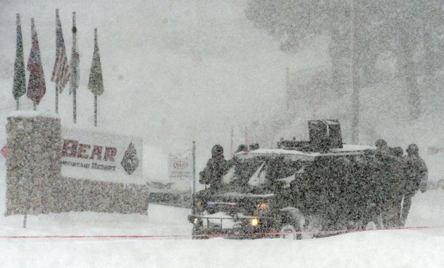 a-san-bernardino-county-sheriff-swat-team-returns-to-the-command-post-at-bear-mountain-near-big-bear-lake-calif-after-searching-for-christopher-jordan-dorner-on-friday-feb-8-2013-search-conditions-have-been-hampered-by-a-heavy-winter-storm-in-the-area-dorner-a-former-los-angeles-police-officer-is-accused-of-carrying-out-a-killing-spree-because-he-felt-he-was-unfairly-fired-from-his-job