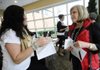 NWA Media/Marc F. Henning
Terrisa Muskrat, left, Cherokee Nation special assistant for government relations, greets Pamela Cagle of Bella Vista on Saturday, Feb. 9, 2013, during an outreach visit by Cherokee Nation representatives to the Center For Non-Profits in Rogers. The visit, one of several planned outreaches for Cherokee citizens in western Arkansas communities, gave Cherokee tribal citizens the chance to upgrade their ID cards and register to vote in upcoming tribal elections. Cagle, whose Cherokee heritage comes from her father's side, said she attended the event to upgrade her old tribal citizenship card to a new photo ID. The next Cherokee Nation outreach in Northwest Arkansas will be on March 2 at the University of Arkansas Law School in Fayetteville.
