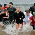 Participants quickly make their way out of the water Saturday during the annual Beaver Lake Polar Pl...