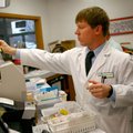 Jonathan Unwer counts pills behind the counter at North Hills Fayetteville Collier Drug Store. Unwer...