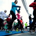 Runners take off for the start of their 8K race Saturday in the Valentine’s 4K/8K in downtown Benton...