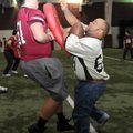 Leon Anderson, right, a Special Olympics athlete from Brinkley, pushes his way past Springdale High ...
