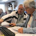 Walter Gaspord, left, gets help with his tax return from Claudine Barnett, an AARP volunteer tax pre...