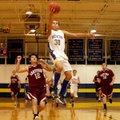 Decatur senior forward Andrew Harris breaks away from Hartford's Brody Funk and puts the ball up for...