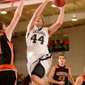Jacob Hall of Pea Ridge takes the ball to the basket Jan. 29 under pressure from Gravette’s Carson P...