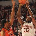 Arkansas junior Marshawn Powell shoots as Auburn senior Noel Johnson (32) defends him, Jan. 16, 2013...