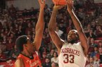 Arkansas junior Marshawn Powell shoots as Auburn senior Noel Johnson (32) defends him, Jan. 16, 2013 in Bud Walton Arena in Fayetteville. The Razorbacks beat the Tigers 88-80 in double overtime.