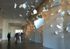 Attendees of the 21c Museum Hotel walk past "A Sudden Gust of Wind" by Serkan Ozkaya on Monday. 