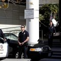 Los Angeles police officers stand alert at the LAPD headquarters in Los Angeles on Tuesday, Feb. 12,...
