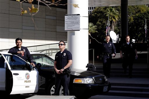 los-angeles-police-officers-stand-alert-at-the-lapd-headquarters-in-los-angeles-on-tuesday-feb-12-2013-police-are-now-investigating-more-than-1000-tips-from-the-public-in-the-search-for-the-christopher-dorner-who-is-suspected-of-a-deadly-revenge-plot-against-the-los-angeles-police-department-the-number-of-tips-has-grown-from-an-initial-250-since-the-city-offered-a-1-million-reward-for-information-leading-to-the-capture-of-dorner