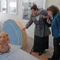 Susan Kennedy, right, of Bentonville and DeLinda Mace of Rogers check out a creature from the sculpt...
