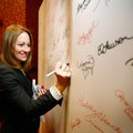 Stephanie Reibling (left) of Rogers signs her name Tuesday to the “I Go Red for...” board during the...